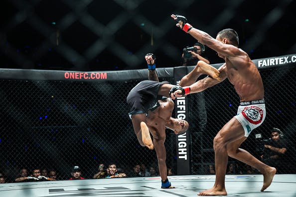 Mixed martial arts (MMA) fighters Adriano Moraes, left, and Kairat Akhmetov contest the Flyweight World Championship Unification Bout at The One: Kings & Conquerors event at the Venetian Macao in Macau, on Saturday, Aug. 5, 2017. Photographer: Billy H.C. Kwok/Bloomberg via Getty Images