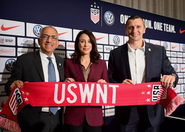 Carlos Cordeiro, U.S. Soccer President, (L) and Kate Markgraf, U.S. Women’s National Team General Manager, pose for a photo with Vlatko Andonovski at a press conference where he was introduced as the U.S. Women's National Team head coach (Credit: Getty Images)
