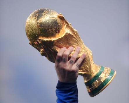 Antoine Griezmann of France holds the World Cup trophy aloft after 2018 FIFA World Cup Russia Final (Photo by