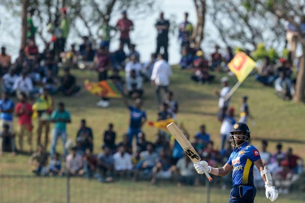 Sri Lanka's Kusal Mendis raises his bat after scoring a half-century (by LAKRUWAN WANNIARACHCHI/AFP via Getty Images)