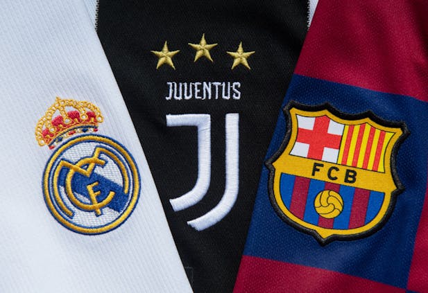 The badges of the three remaining clubs in the European Super League (by Visionhaus/Getty Images)