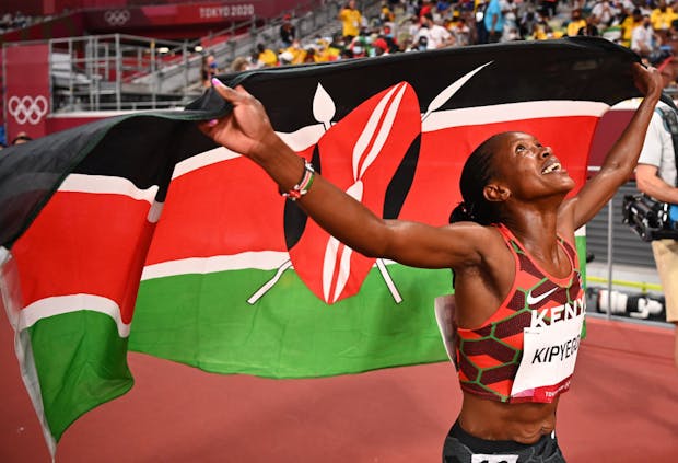 Faith Kipyegon of Team Kenya celebrates after winning gold in the women's 1500m final at the Tokyo 2020 Olympic Games (by Dylan Martinez - Pool / Getty Images)