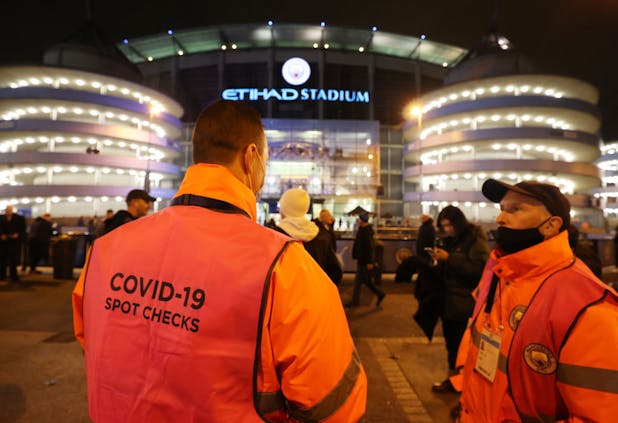 A Covid-19 spot checker outside the Premier League match between Manchester City and Leeds United at Etihad Stadium on December 14. (Photo by Clive Brunskill/Getty Images)