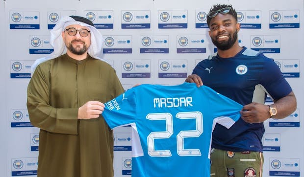 Mohamed Jameel Al Ramahi, chief executive officer of Masdar (left) poses with former Manchester City player Micah Richards (right). Photo: Manchester City