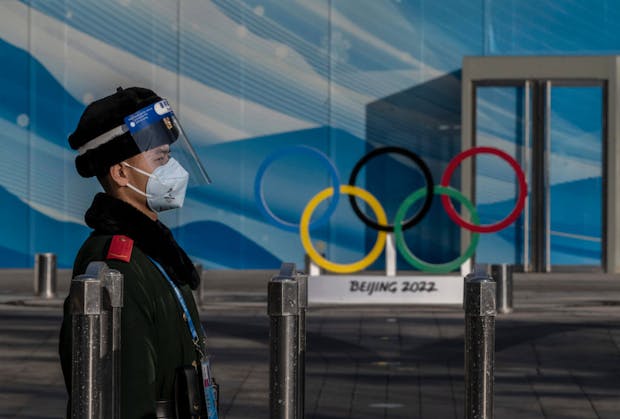 A police officer stands guard near the main media centre at the Olympic Park. (Photo by Kevin Frayer/Getty Images)