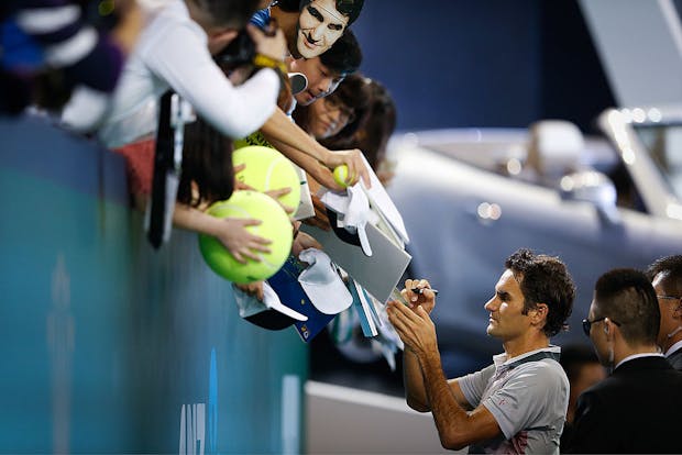 Roger Federer signs autographs at the Shanghai Masters in China. (Photo by Lintao Zhang/Getty Images).
