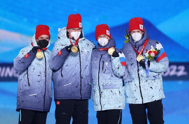 Alexey Chervotkin, Alexander Bolshunov, Denis Spitsov and Sergey Ustiugov of Team ROC pose with their gold medals after the men's cross-country skiing 4x10km ceremony at the Beijing 2022 Winter Olympic Games (by Cameron Spencer/Getty Images)
