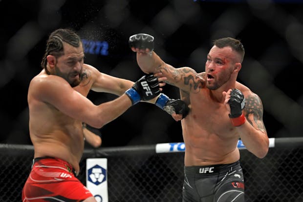 Colby Covington (R) punches Jorge Masvidal in their welterweight fight during UFC 272 on March 5, 2022 (by David Becker/Getty Images)