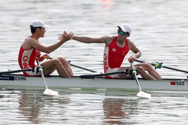 Man Sun and Junjie Fan of China celebrate after crossing the finish line during the Men's Lightweight Single Sculls race at the 2019 World Rowing Championships in Linz-Ottensheim, Austria (by Naomi Baker/Getty Images)