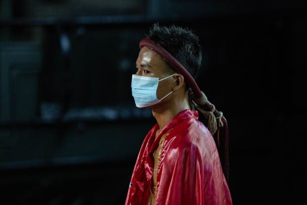  A Muay Thai boxer wears a face mask as he enters the ring at the Radjadamnern Boxing Stadium in Bangkok. (Photo by Lauren DeCicca/Getty Images)