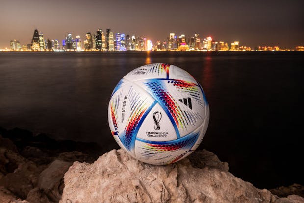 An official Fifa World Cup Qatar 2022 ball sits on display in front of the skyline of Doha on March 31, 2022 (by David Ramos/Getty Images)