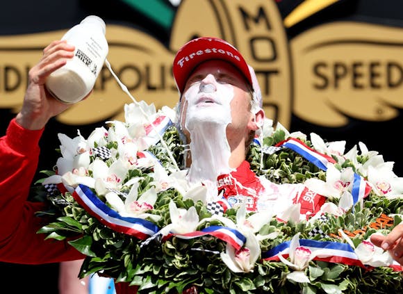 Marcus Ericsson of Sweden celebrates in Victory Lane by pouring milk on his head after winning the 2022 Indianapolis 500. (Photo by Jamie Squire/Getty Images)