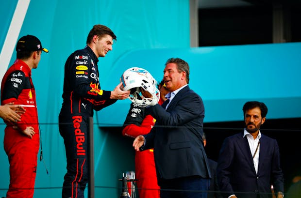 Miami GP winner Max Verstappen is presented with a Miami Dolphins football helmet from former Dolphins icon and Pro Football Hall of Famer Dan Marino. (Credit: Getty Images)