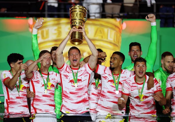 Marcel Halstenberg of RB Leipzig lifts the DFB-Pokal trophy after the side's victory in the 2022 DFB-Pokal final. (Photo by Alex Grimm/Getty Images).