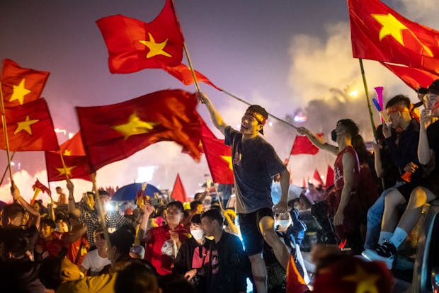 Fans celebrate outside the My Dinh Stadium as Vietnam successfully defends the SEA Games men's football title in 2022 in Hanoi (by Linh Pham/Getty Images)