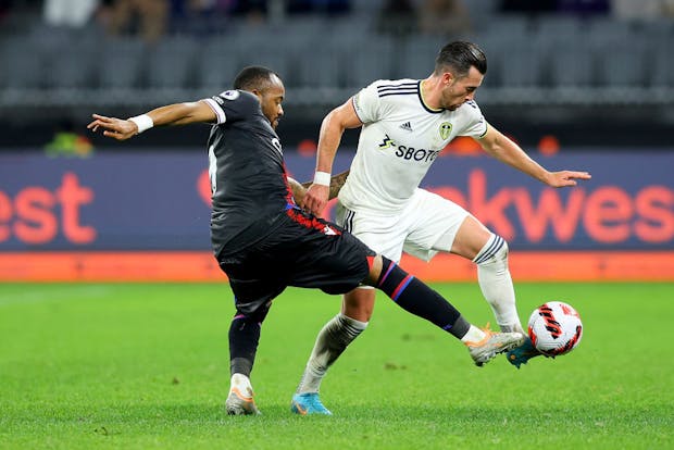 Jordan Ayew of Crystal Palace attempts to dispossess Jack Harrison of Leeds United (Photo by James Worsfold/Getty Images)