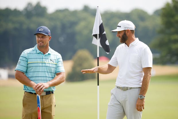 Bryson DeChambeau (l) and Dustin Johnson play at the recently held LIV Golf event in Bedminster, New Jersey. (Photo by Cliff Hawkins/Getty Images)