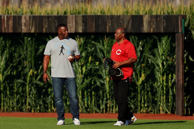 Baseball Hall of Famer Ken Griffey Jr. (left) and his father, former Major League Baseball star Ken Griffey Sr., take the field as part of pre-game ceremonies for the 2022 MLB Field of Dreams Game. (Photo by Michael Reaves/Getty Images)