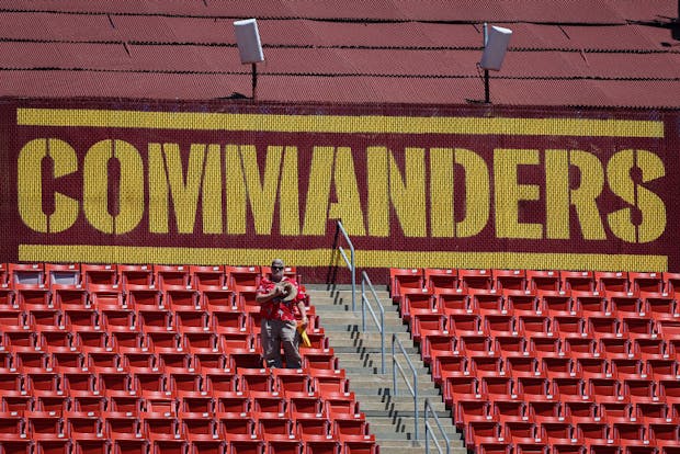 A fan looks on from an empty section of stands at FedEx Field, home of the National Football League's Washington Commanders. (Photo by Scott Taetsch/Getty Images)
