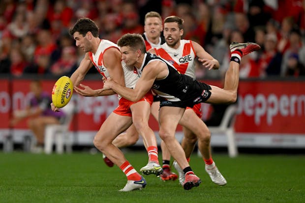 Robbie Fox of the Sydney Swans is tackled during AFL match on August 21, 2022 (by Morgan Hancock/AFL Photos/via Getty Images)