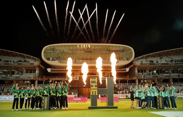 The Southern Brave Men (left) and Oval Invincibles Women (right) lift their trophies after The Hundred Final at Lords Cricket Ground. (Photo by Tom Jenkins/Getty Images).
