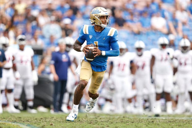 PASADENA, CALIFORNIA - SEPTEMBER 17: Dorian Thompson-Robinson #1 of the UCLA Bruins scrambles and looks to make a pass play against the South Alabama Jaguars during the first half at Rose Bowl on September 17, 2022 in Pasadena, California. (Photo by Michael Owens/Getty Images)
