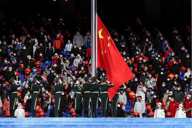 China's national flag is lowered during the closing ceremony of the 2022 Winter Olympic Games (by Maja Hitij/Getty Images)