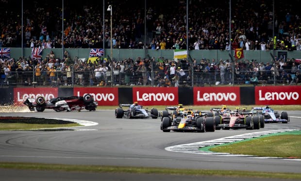 Max Verstappen of Red Bull Racing in the lead as Alfa Romeo's Guanyu Zhou crashes during the start of the 2022 British Grand Prix (by ANP via Getty Images)
