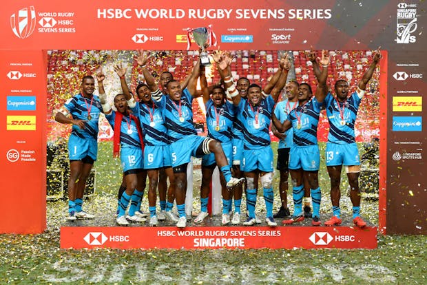 Fiji celebrates with winners' trophy after their cup final victory against New Zealand during the Singapore Rugby Sevens (Photo by Yong Teck Lim/Getty Images)