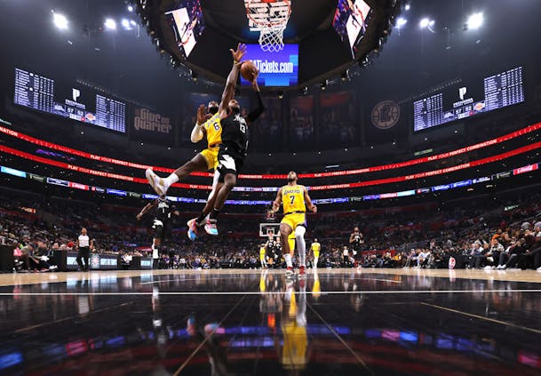 Paul George, #13 of the LA Clippers, is fouled by LeBron James, #6 of the Los Angeles Lakers (by Harry How/Getty Images)