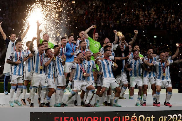 Lionel Messi lifts the trophy after winning the FIFA World Cup (Photo by Richard Sellers/Getty Images)
