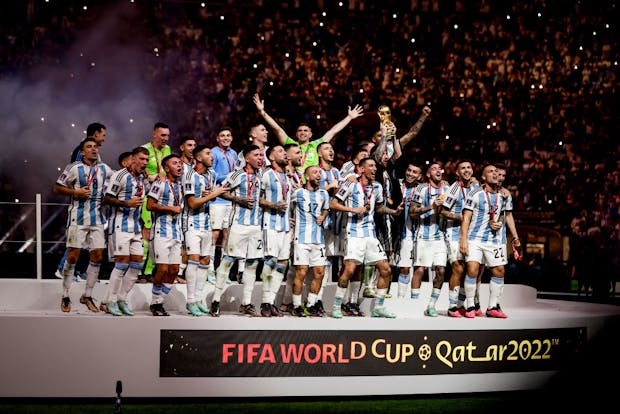 Argentina lift the trophy following the 2022 Fifa World Cup final at Lusail Stadium in Doha (by Eric Verhoeven/Soccrates/Getty Images)