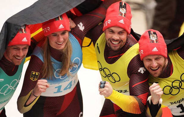 Team Germany react after winning gold during the Luge Team Relay at the Beijing 2022 Winter Olympics (by Adam Pretty/Getty Images)