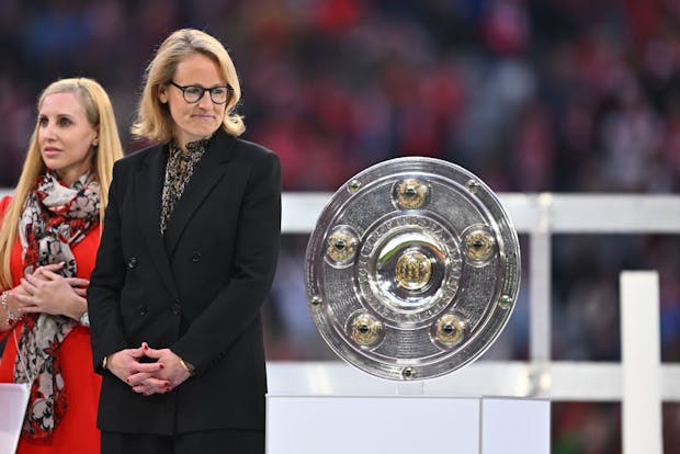 Donata Hopfen, CEO of DFL, stands next to the Bundesliga trophy. (by Markus Gilliar/GES-Sportfoto via Getty Images)