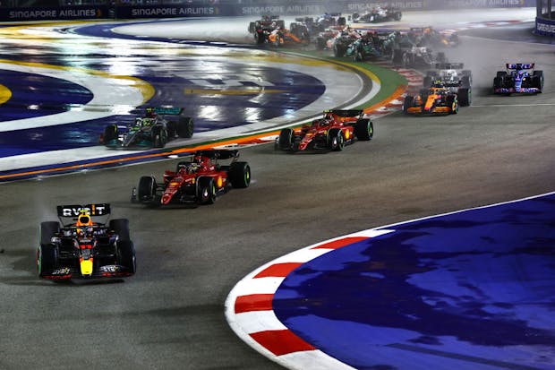Sergio Perez, driving the Oracle Red Bull Racing RB18, leads the rest of the field at the start of the 2022 Singapore Grand Prix (by Mark Thompson/Getty Images,)