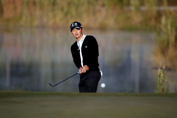 Yeongsu Kim of South Korea hits a chip shot on the third hole during the third round of the CJ Cup (Photo by Mike Mulholland/Getty Images for The CJ Cup)
