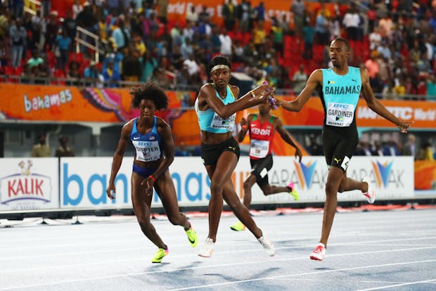 Steven Gardiner passes the baton to Shaunae Miller-Uibo of the Bahamas at the 2017 World Athletics Relays in Nassau (by Matthew Lewis/Getty Images for IAAF)