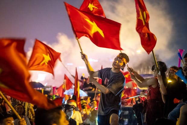Vietnamese fans celebrate winning the SEA Games men's football gold medal, May 2022 in Hanoi. (Photo by Linh Pham/Getty Images)
