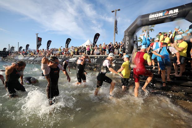 Pro athletes exit the water during the Ironman World Championship on October 8, 2022 in Kailua Kona, Hawaii (by Tom Pennington/Getty Images for Ironman)