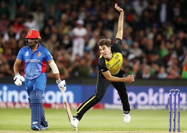 Pat Cummins of Australia and Gulbadin Naib of Afghanistan in action during the 2022 T20 World Cup (by Sarah Reed/Getty Images)
