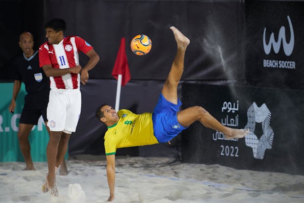 Igor Matheus of Brazil attempts a scissor kick shot on goal in front Jesus Martinez of Paraguay (Photo by Manuel Queimadelos/Quality Sport Images/Getty Images)