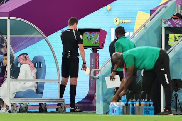 Referee Daniel Siebert checks the VAR monitor during the 2022 Fifa World Cup (by Youssef Loulidi/Fantasista/Getty Images)