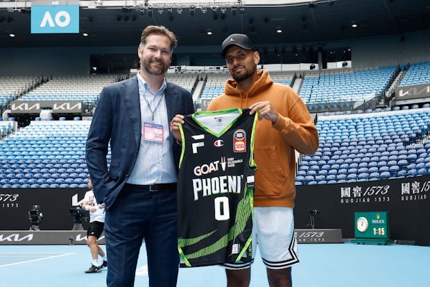 South East Melbourne Phoenix CEO, Tommy Greer, presents Nick Kyrgios with a Phoenix jersey on January 12, 2023 (by Darrian Traynor/Getty Images)