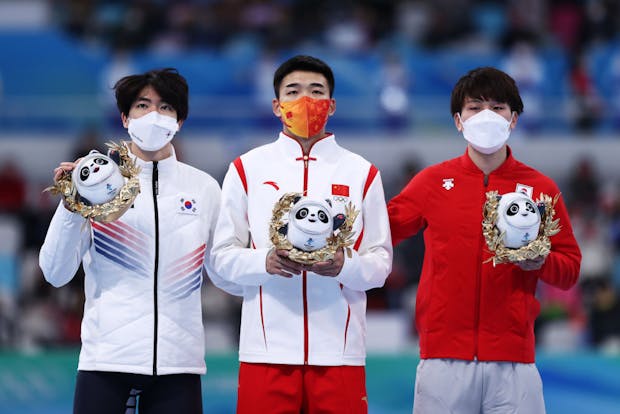 Tingyu Gao of Team China (C), Min Kyu Cha of Team South Korea (L) and Wataru Morishige of Team Japan (R) at the Beijing 2022 Winter Olympic Games. (Photo by Dean Mouhtaropoulos/Getty Images)