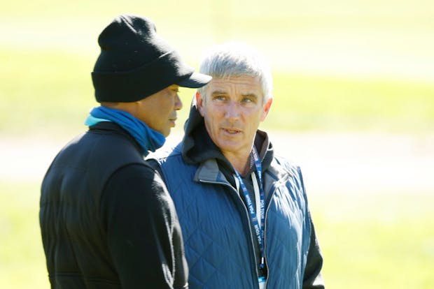 PGA Tour commissioner Jay Monahan with Tiger Woods (by Cliff Hawkins/Getty Images)