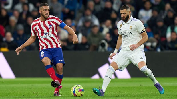 Koke of Atletico de Madrid is challenged by Karim Benzema of Real Madrid (Photo by Angel Martinez/Getty Images)