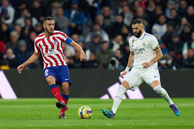 Koke of Atletico de Madrid is challenged by Karim Benzema of Real Madrid (Photo by Angel Martinez/Getty Images)