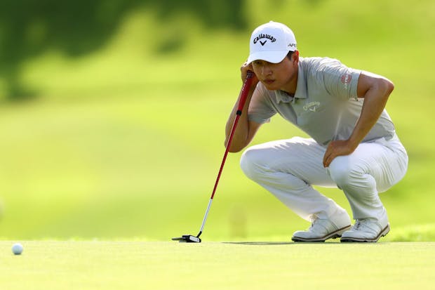 Jeunghun Wang of South Korea lines up a putt (Photo by Yong Teck Lim/Getty Images)