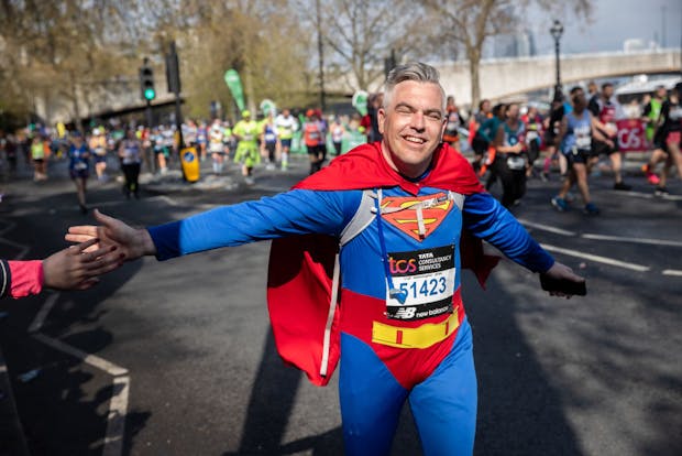 A man dressed as Superman runs the 2023 London Marathon (by Sam Mellish/Getty Images)