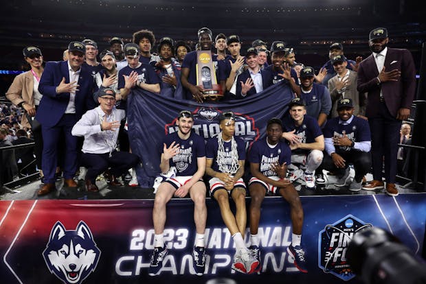 The Connecticut Huskies pose with the championship trophy after defeating the San Diego State Aztecs in the NCAA Men's Basketball Tournament National Championship game (Getty Images)